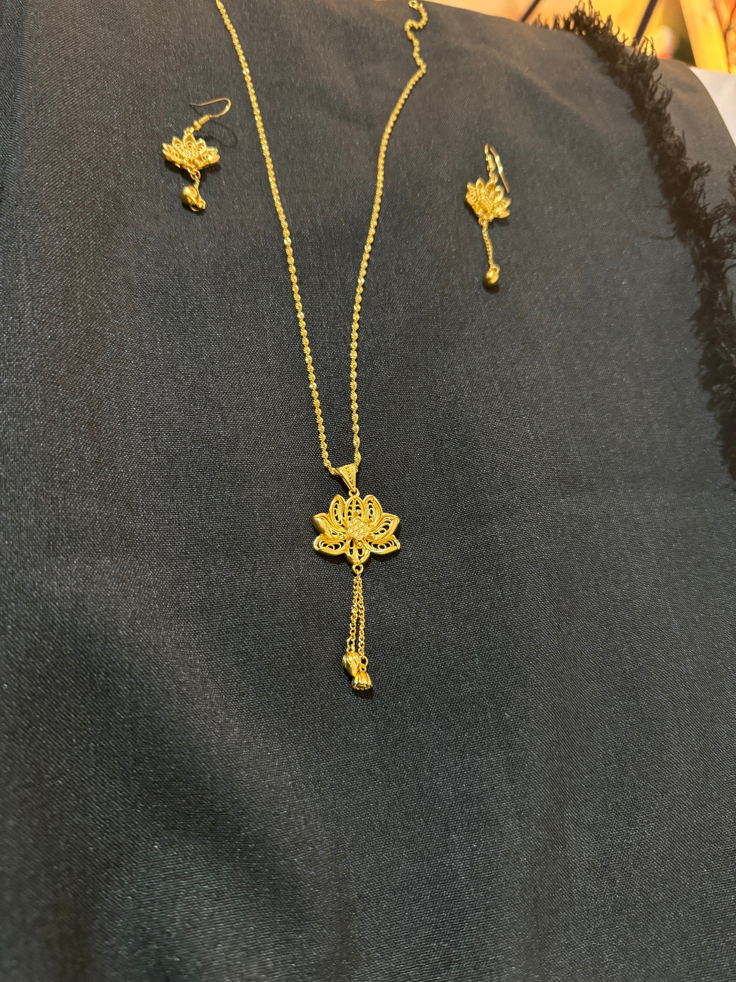 Gold look necklace with small hibiscus pendant and matching earrings